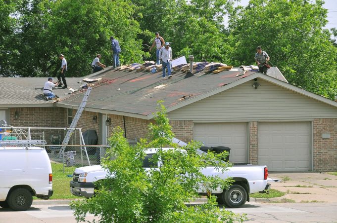worker repairing the roof of a house
