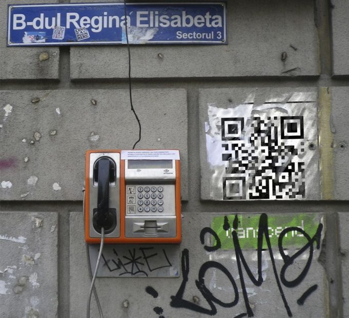 A customer paying by phone QR code at a small shop